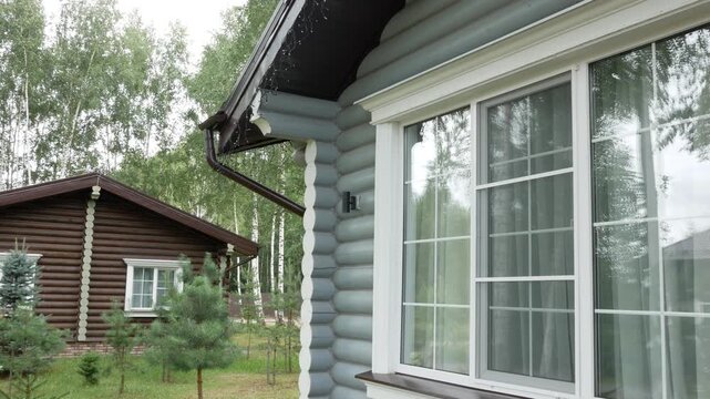 Eco modern village with houses from wooden walls made of natural round logs. Construction of a wooden house made from timber logs.