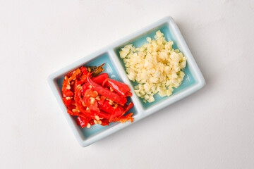 Finely chopped fresh red chilies and chopped garlic for dipping sauces for shabu, nabe, and other...