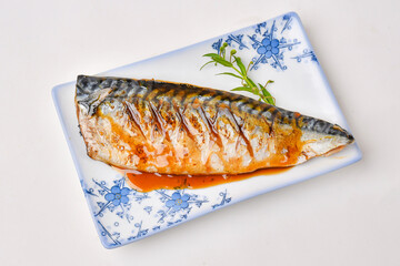 Grilled Saba fish on a plate with delicious sauce and ready to eat.