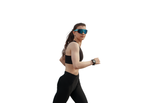 Woman jogging by the waterfront in black activewear and sunglasses, embracing an outdoor fitness routine against transparent background