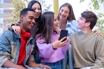 Five students having fun with mobile phones creating content on social media.