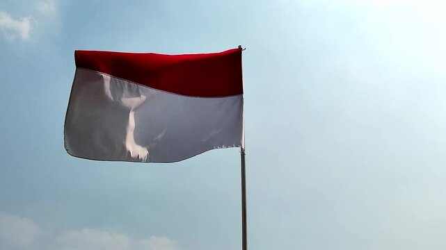 Indonesian Red White Flag Waving in the Bright Clear Blue Sky Day