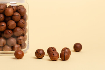 Macadamia nuts on a beige background.