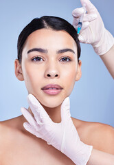 Woman, hands and confident for facelift with needle in studio on blue background for grooming and beauty. Female person, aesthetics and portrait with cosmetics for skincare, filler and anti aging