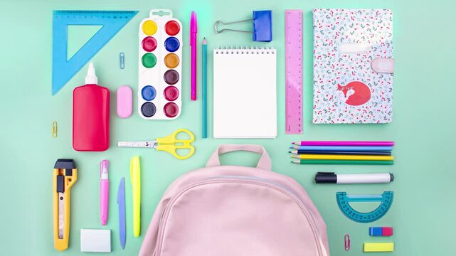 Colorful school supplies moving from school pink bag on mint green background. Back to school concept. Stop motion animation. Flay lay top view school supplies pastel colors