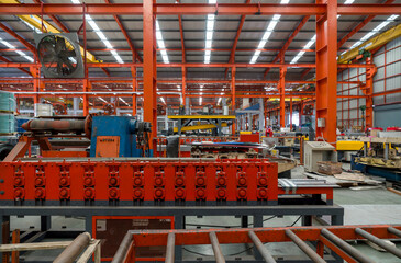 A robust industrial machine engaged in the process of manufacturing. Large conveyor belt are in the...