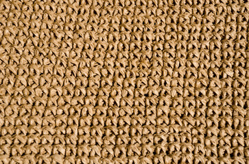 Beige raffia crochet texture. Eco-friendly handmade material.
