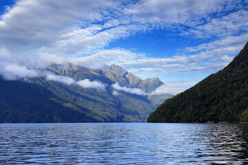view to the cloudy mountains of the Doubtful Sound in Fiordland, south west of New Zealand