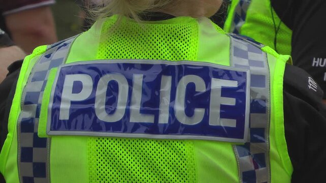 UK Police. CU high visibility uniform on police officer.