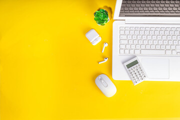 Stylish right yellow minimalistic workplace with notebook