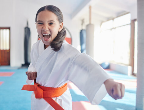Martial arts, karate and girl in studio for fitness, training and fight with orange belt, shout or energy. Student, kung fu and practice in dojo as workout for self defense, tai chi and taekwondo - Powered by Adobe
