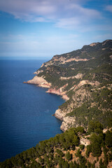 Banyalbufar in Mallorca - rocky cliffs on a summer day with blue water