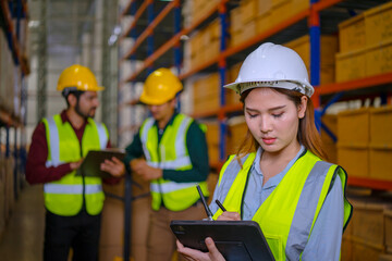 Blue collar workers are working at warehouse.
