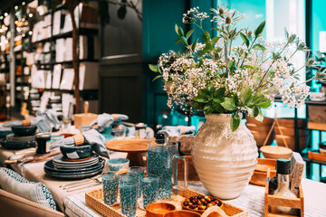 View of assortment of decor for interior shop in store of shopping center. Home accessories and household products for dining room in store of shopping centre. View of beautifully set table. Home