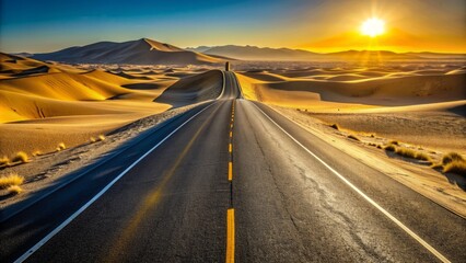 Fototapeta premium Endless stretch of deserted asphalt highway winds its way through vast, sun-baked dunes, golden light casting long shadows on the empty, adventurous road.