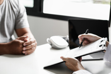 Female doctors who treat patients make an appointment to listen to the results after a physical examination and explain medical information and diagnose the disease. Medical concepts and good health