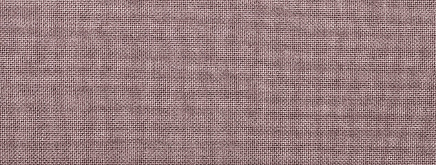 Texture brown color background from textile material with wicker pattern, macro. Vintage umber fabric cloth,