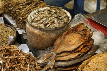 Mixed dried fish are displayed and  sold at a fish market, Different types of dried fish are sold by a street vendor, All types of dried salted fish in the Asian biggest seafood market