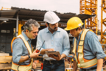 Professional construction engineer workers team working cooperate together consulting looking at...