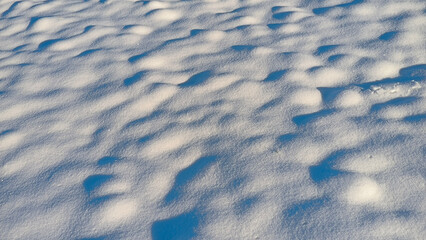 ground covered with snow in sunlight