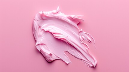 A pink blob of makeup is spread across a pink background