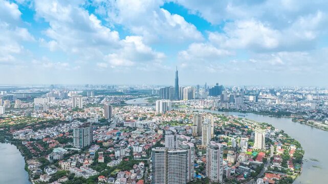 Panoramic view of Saigon, Vietnam from above at Ho Chi Minh City's central business district. Cityscape with Landmark 81 skyscraper and many buildings, local houses, rivers.