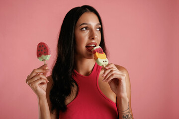 Ice cream in hands. Beautiful young woman is against background