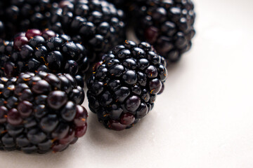 Fresh ripe juicy blueberry on a white ceramic surface. Sweet healthy organic vitamin berries. Macro shot