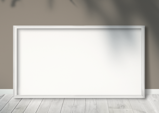 White picture frame leaning against on a beige wall