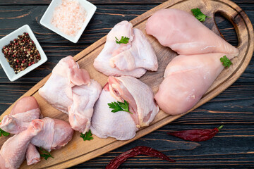 Raw mixed chicken meat parts  for cooking on rustic background