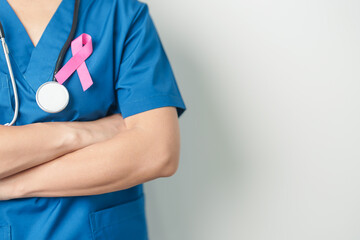 Pink October Breast Cancer Awareness month, woman doctor with pink Ribbon in hospital for support people life and illness. National cancer survivors month, Mother and World cancer day concept