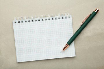 Notebooks and pen on light background, top view. Space for text