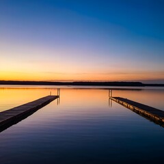 Wooden pier extending into a calm lake at dusk