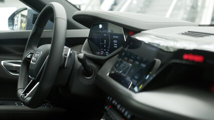 Close-up of a new electric car's interior, showcasing sleek design and cutting-edge technology. Perfect for highlighting modern automotive luxury and the future of eco-friendly transportation.