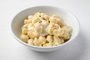 Macaroni cheese in bowl on white background