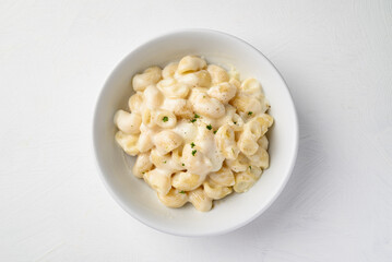 Macaroni cheese in bowl on white background, Top view