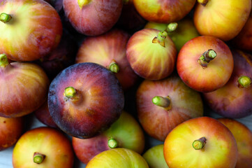 Close-up of a fresh fig , set against a dark, textured background to highlight its vibrant purple color.