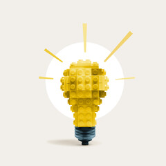 A model of a light bulb assembled from construction blocks. Art collage.