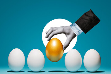 The hand chooses the golden egg among the white eggs.