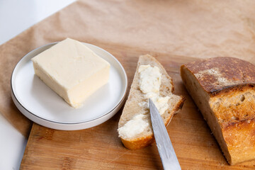  Fresh homemade sourdough bread with a buttered slice