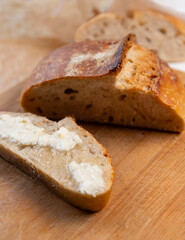 Beautiful homemade sourdough bread and a slice spread with butter