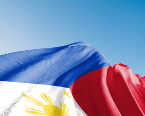 Philippines national flag cloth fabric waving on beautiful sky blue Background.