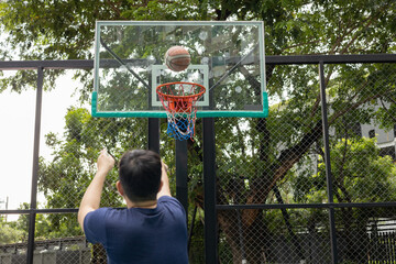 Fototapeta premium Man Stretching on Basketball Court Outdoors