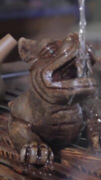 Traditional Chinese Tea Ceremony and pour the tea in a glass of the clay. Pouring Tea With The Help Of Ladle