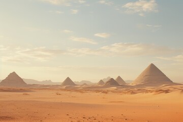 Desert landscape with the pyramids on the horizon.
