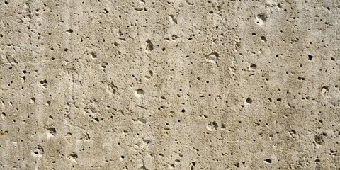 Fototapeta premium A close-up of a natural concrete texture, with rough, porous details and various shades of light gray, perfect as a background or for design elements in architecture and construction