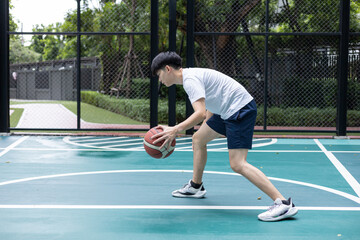 Focused Basketball Player Dribbling on Court