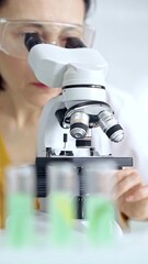 Woman scientist using microscope in laboratory. Microbiology science concept