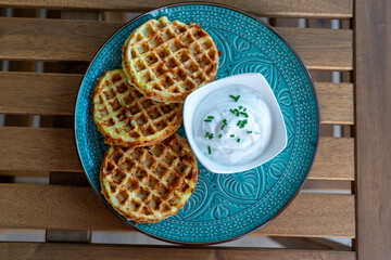 zucchini waffles gofri with sour cream dip on a plate