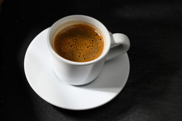 cup of delicious Turkish coffee on a black background